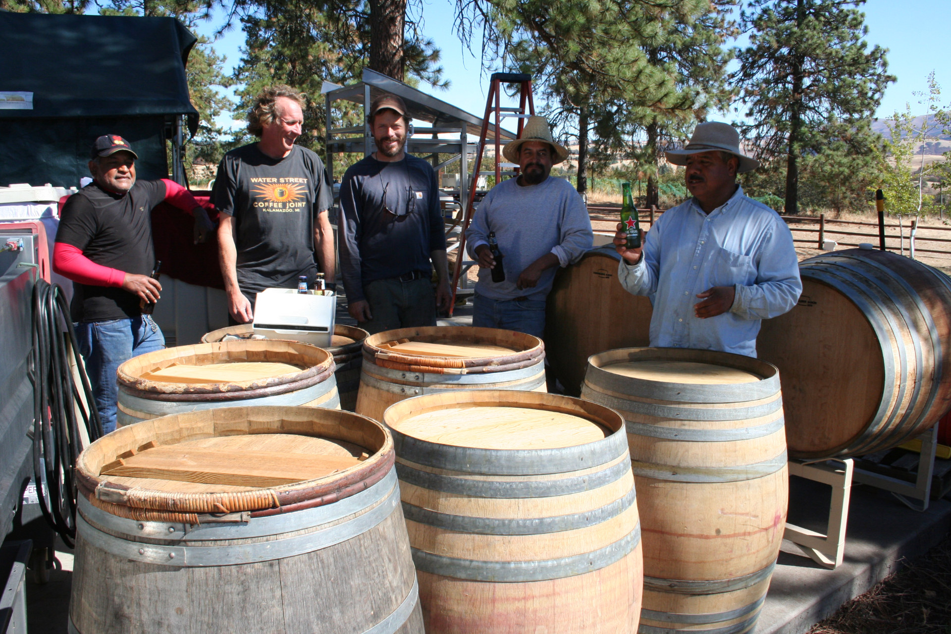 Owners and workers gathered around barrels